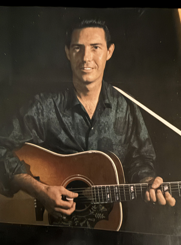 Portrait of Frankie Miller with guitar